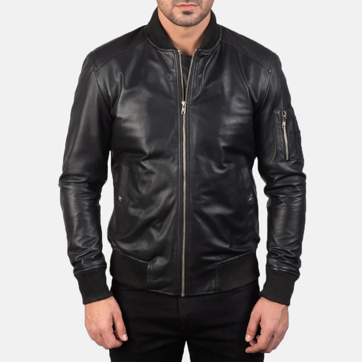"Bomia MA-1 Black Leather Bomber Jacket by MordenJacket – a sleek reinterpretation of the classic MA-1 bomber, crafted in smooth black leather with ribbed cuffs, utility pocket on the sleeve, and a timeless silhouette for everyday edge."
front pose